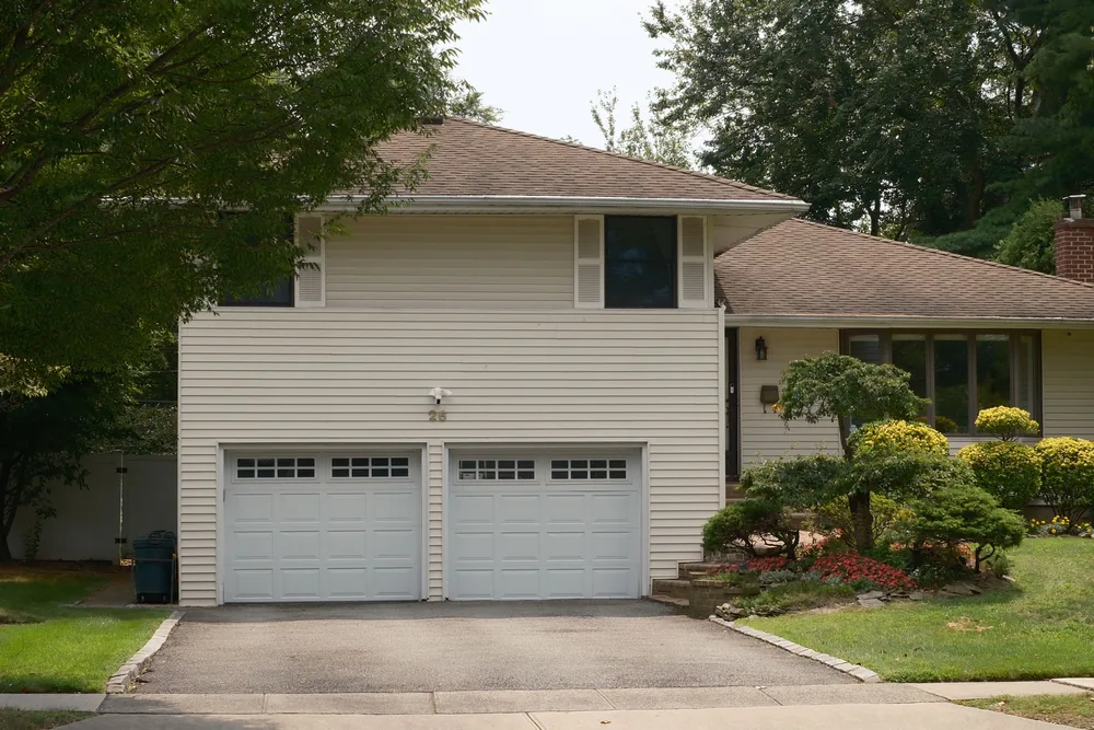 A tidy house frontage with clean beds and trimmed shrubs